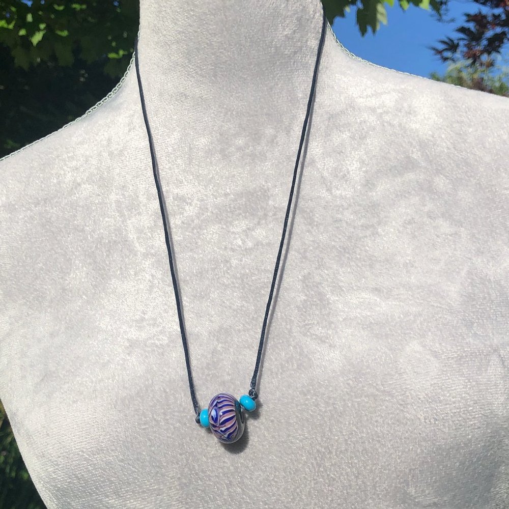 Necklace with handcrafted blown glass bead on  a 26" satin cord